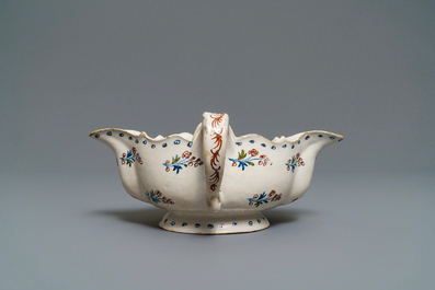 A polychrome Brussels faience '&agrave; la haie fleurie' sauce boat, 18th C.